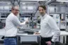 Christian Wimmer of Rosenberger shows Kistler's Stefan Schäfer how the maXYmos process monitoring system is integrated.