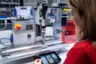 The maXYmos process monitoring system from Kistler guides this production employee through the assembly process.